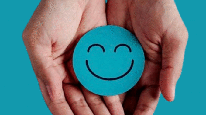 Dopamine Menu Two open hands gently hold a turquoise circle with a simple smiling face on it, symbolizing joy, calm, and positivity.