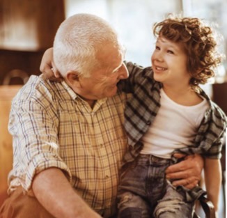 Grandfather and grandchild sitting together, illustrating how legacy lives on through relationships